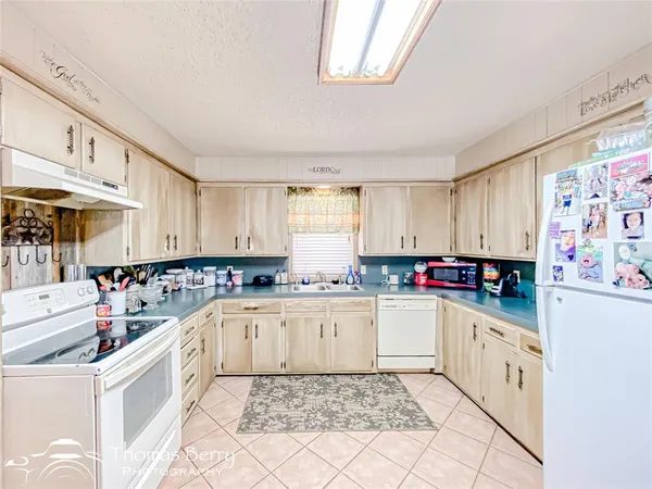 a kitchen with a sink a stove and cabinets