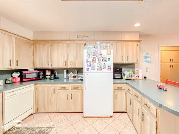a kitchen with stainless steel appliances granite countertop a refrigerator sink and cabinets
