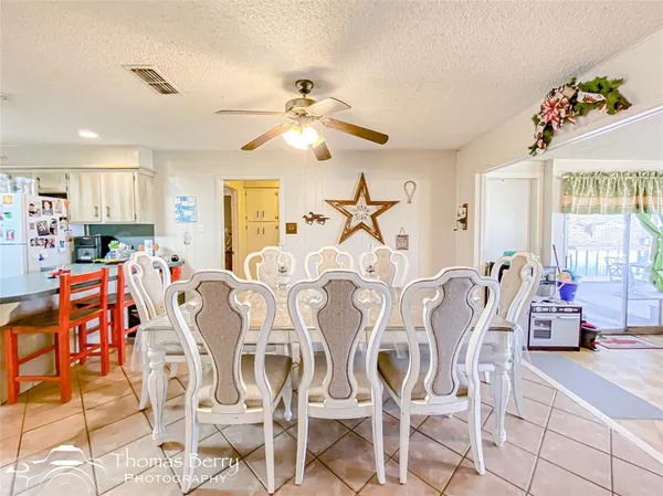 a dining room with furniture a chandelier and window