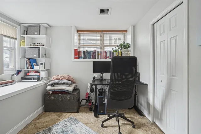 a room with furniture a rug and a window