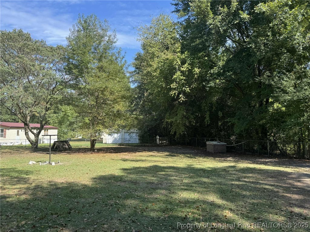 212 Grummen Road Hope Mills, NC 28348 - Photo 12 of 14 a view of a swimming pool and trees in the background