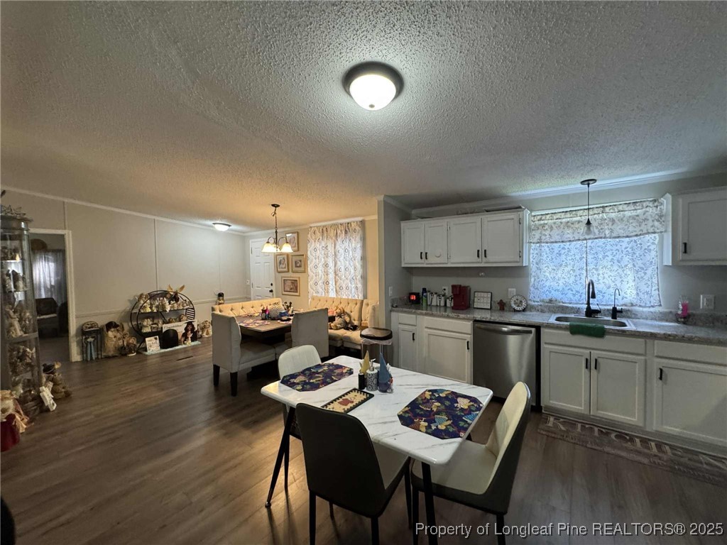 212 Grummen Road Hope Mills, NC 28348 - Photo 4 of 14 a kitchen with a table chairs stove and cabinets