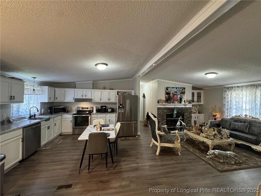 212 Grummen Road Hope Mills, NC 28348 - Photo 5 of 14 a living room with stainless steel appliances furniture wooden floor and a kitchen view