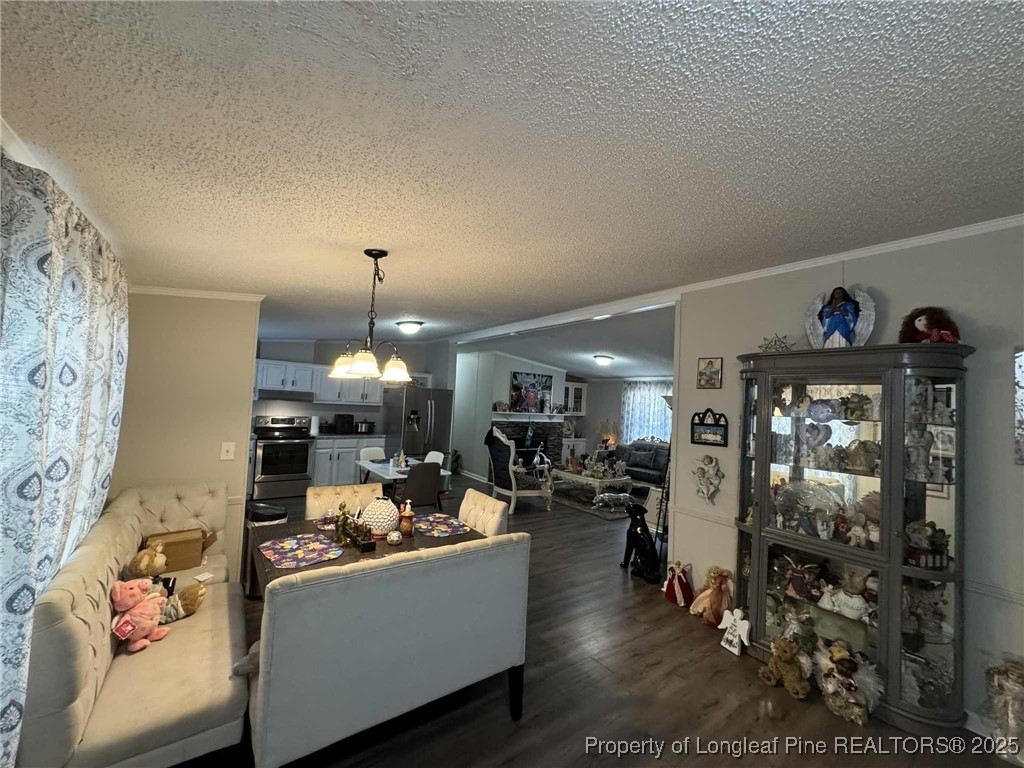 212 Grummen Road Hope Mills, NC 28348 - Photo 7 of 14 a living room filled with furniture and a chandelier