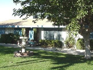 16680 Tenaja(pool) Road Apple Valley, CA 92307 - Photo 1 of 1 a front view of a house with garden
