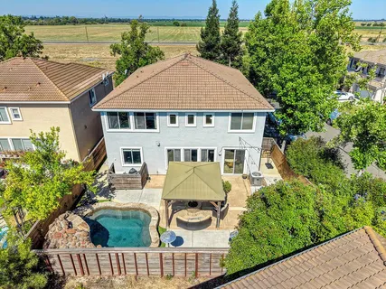 an aerial view of a house with garden space and street view