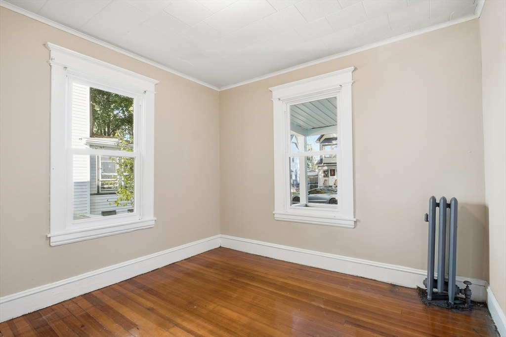 51-53 Abbe Avenue Springfield, MA 01107 - Photo 14 of 42 a view of an empty room with wooden floor and a window