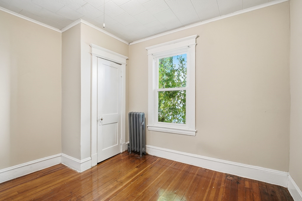 51-53 Abbe Avenue Springfield, MA 01107 - Photo 18 of 42 an empty room with wooden floor and window