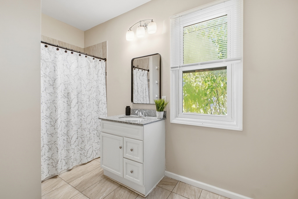 51-53 Abbe Avenue Springfield, MA 01107 - Photo 19 of 42 a bathroom with a sink a mirror and a window