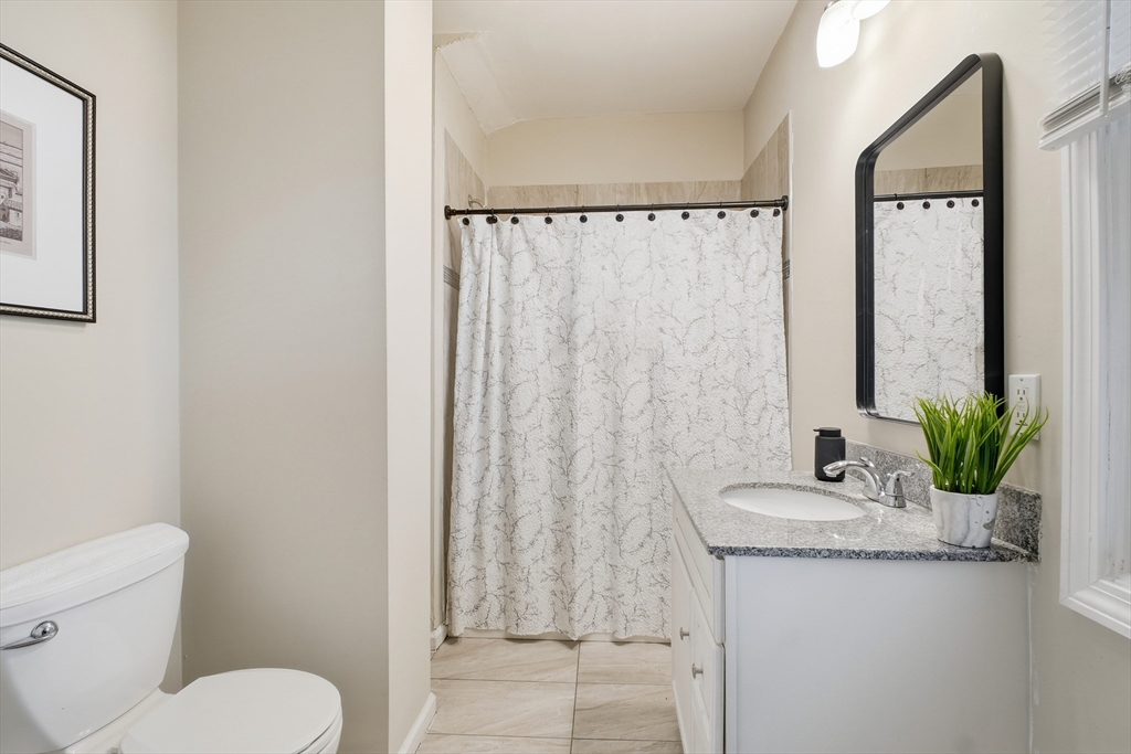 51-53 Abbe Avenue Springfield, MA 01107 - Photo 20 of 42 a bathroom with a granite countertop sink and a mirror