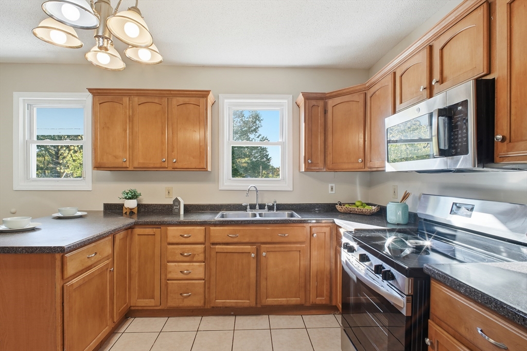 51-53 Abbe Avenue Springfield, MA 01107 - Photo 25 of 42 a kitchen with a sink cabinets and window