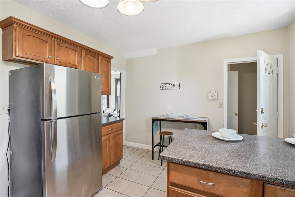 51-53 Abbe Avenue Springfield, MA 01107 - Photo 27 of 42 a kitchen with stainless steel appliances granite countertop a refrigerator a stove and a sink with cabinets
