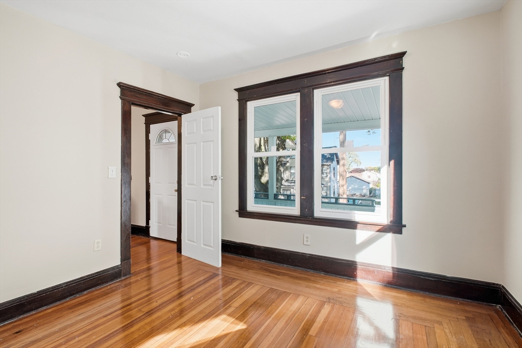51-53 Abbe Avenue Springfield, MA 01107 - Photo 29 of 42 a view of an empty room with wooden floor and a window