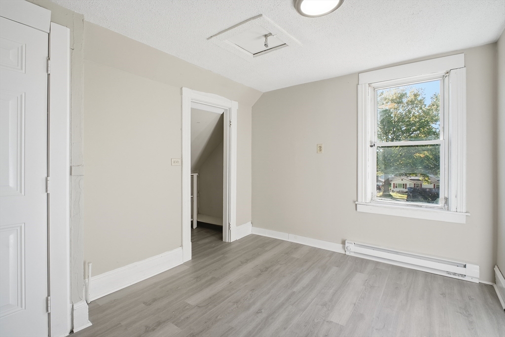 51-53 Abbe Avenue Springfield, MA 01107 - Photo 36 of 42 an empty room with wooden floor and windows