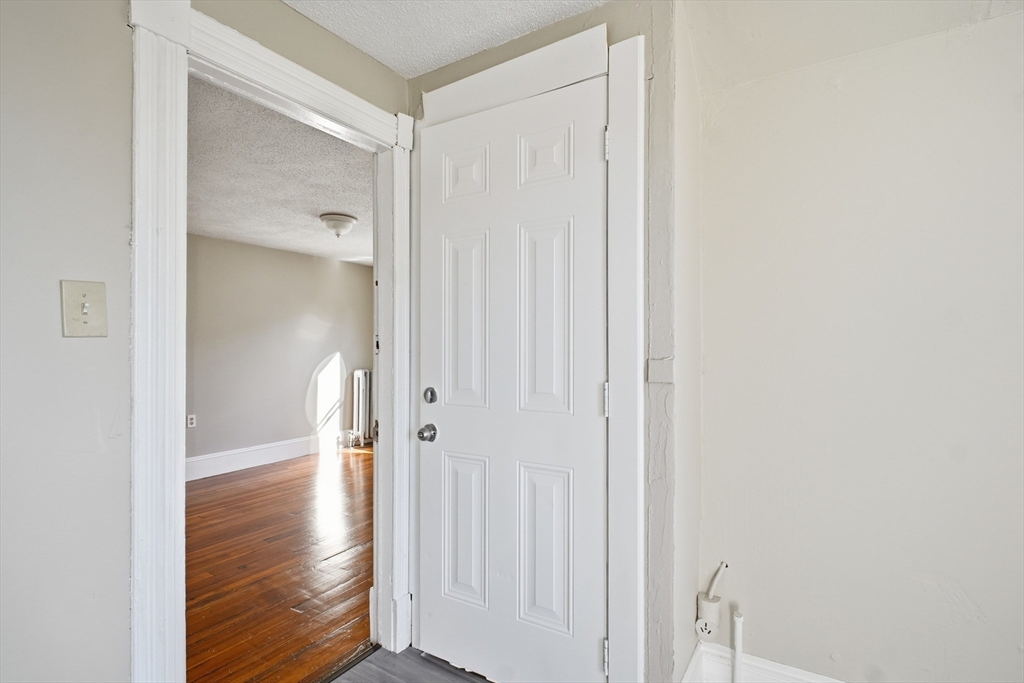 51-53 Abbe Avenue Springfield, MA 01107 - Photo 37 of 42 a view of a hallway with wooden floor