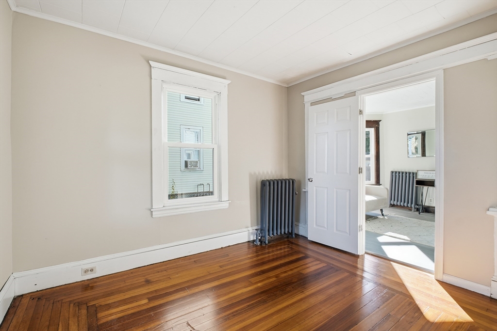 51-53 Abbe Avenue Springfield, MA 01107 - Photo 10 of 42 a view of an empty room with wooden floor and a window