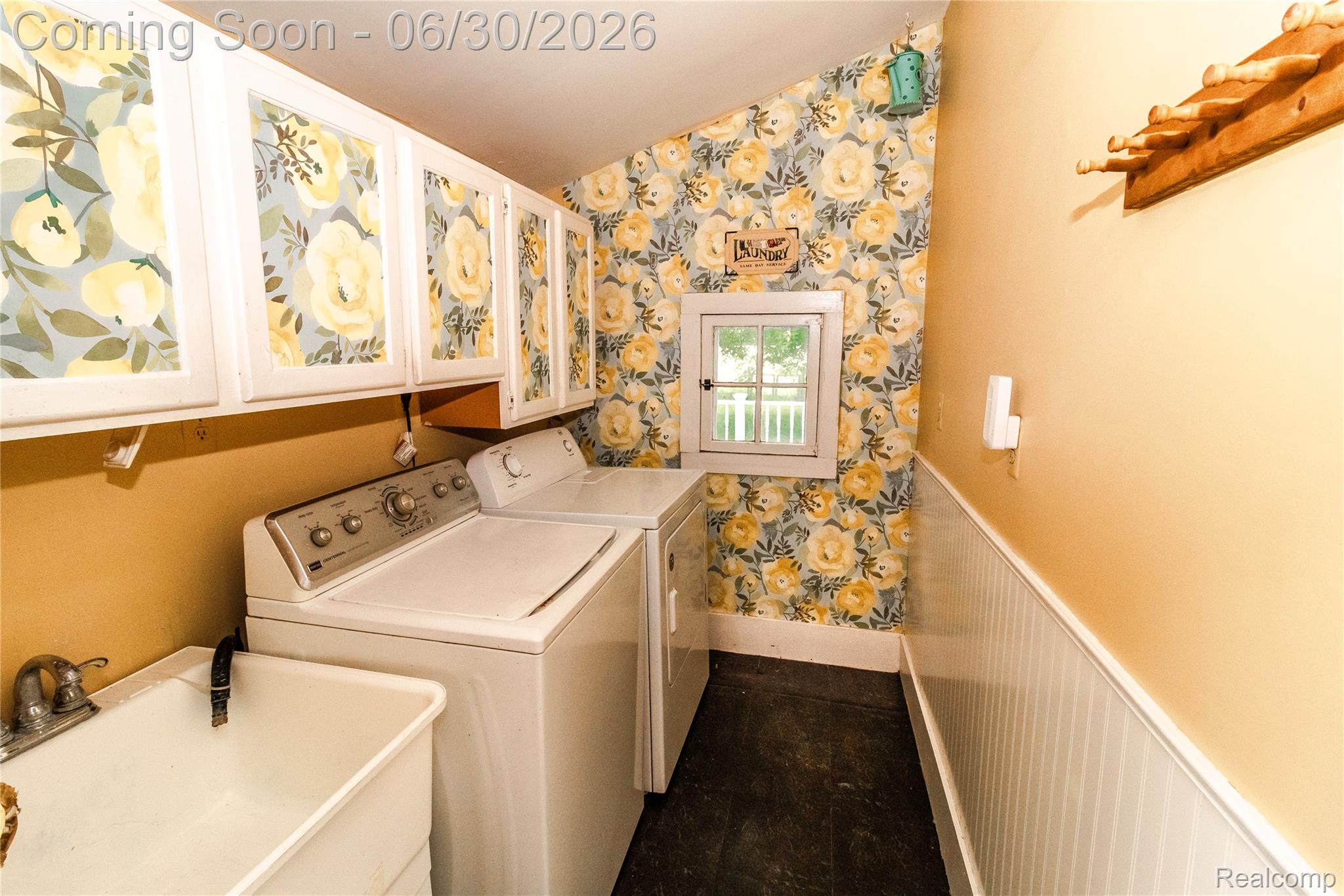 8150 Norman Road Imlay City, MI 48444 - Photo 14 of 58 Dedicated laundry space featuring white cabinetry with decorative inserts, a utility sink, and beadboard paneling