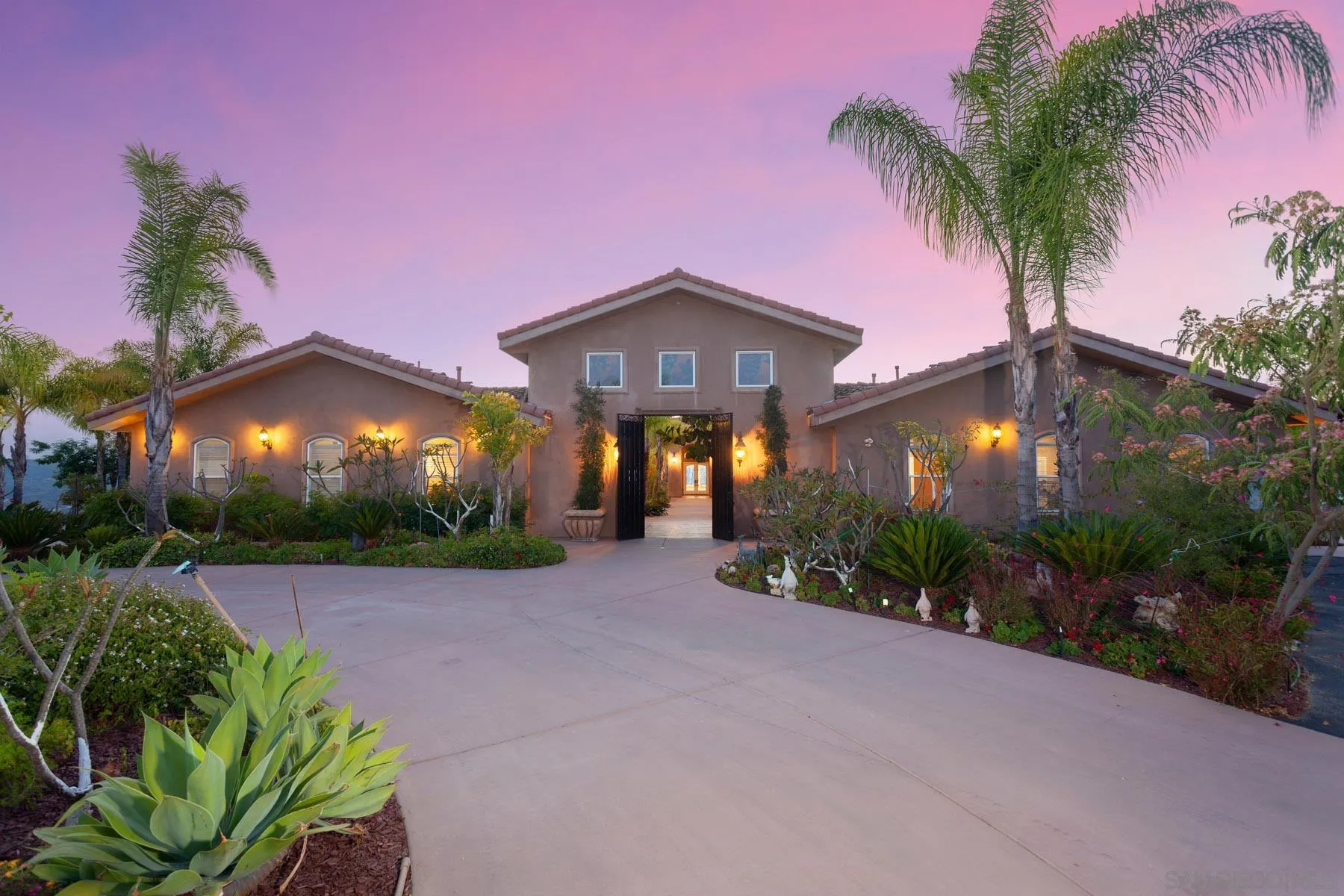 29314 Twin Oaks Valley Road Vista, CA 92084 - Photo 3 of 74 a front view of a house with a yard and a garden