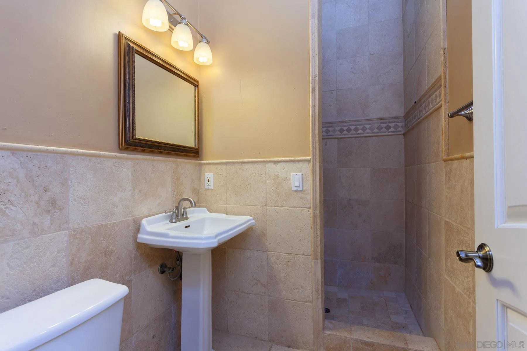 29314 Twin Oaks Valley Road Vista, CA 92084 - Photo 34 of 74 a bathroom with a sink mirror and toilet