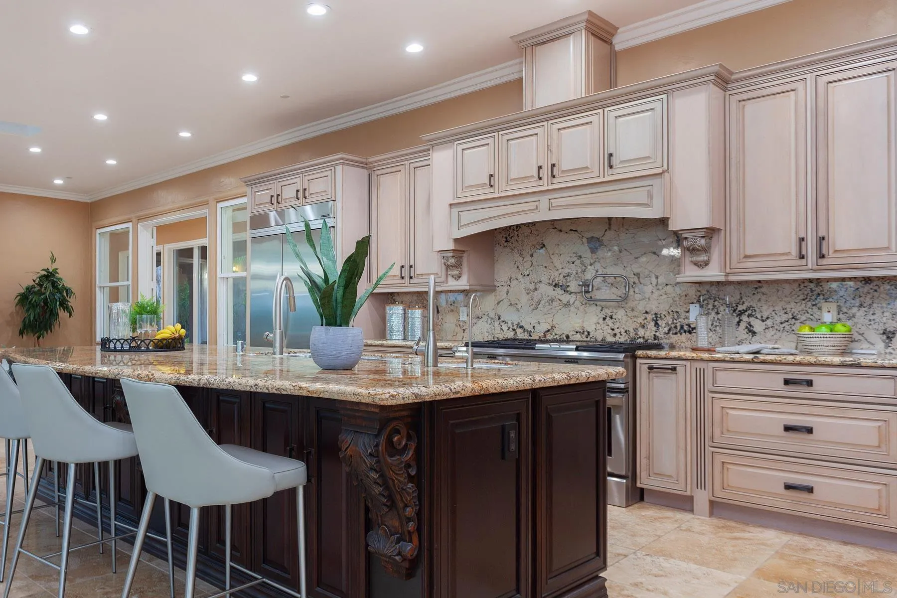 29314 Twin Oaks Valley Road Vista, CA 92084 - Photo 48 of 74 a kitchen with kitchen island granite countertop a table and chairs in it