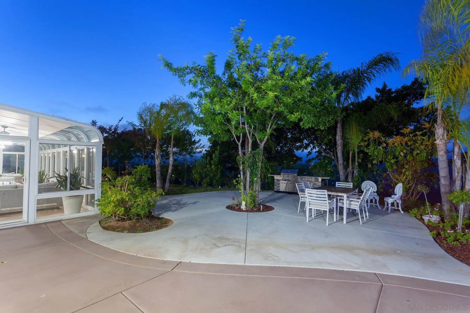 29314 Twin Oaks Valley Road Vista, CA 92084 - Photo 50 of 74 a view of a patio with table and chairs potted plants and palm tree