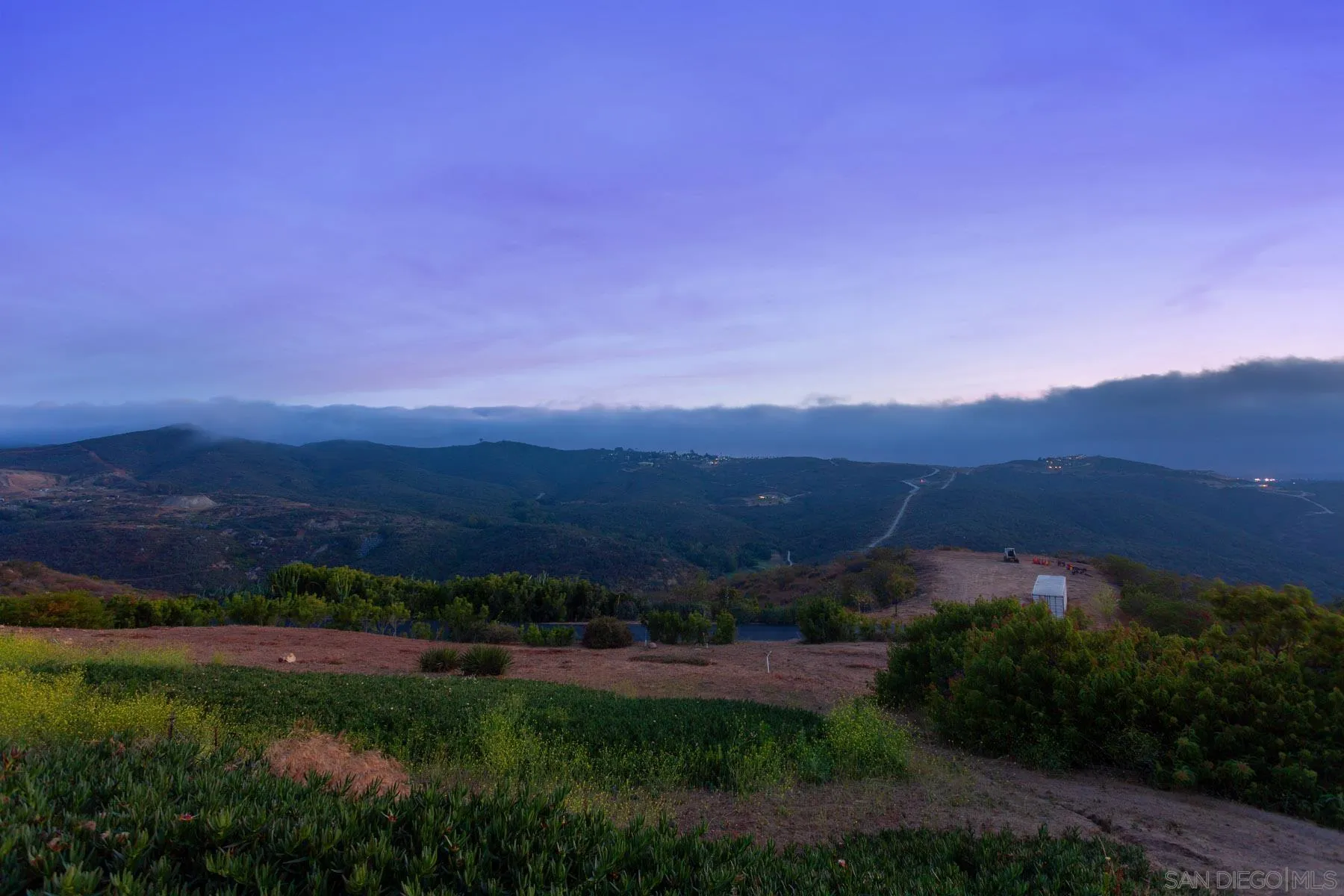 29314 Twin Oaks Valley Road Vista, CA 92084 - Photo 65 of 74 a view of a grassy field with mountains in the background