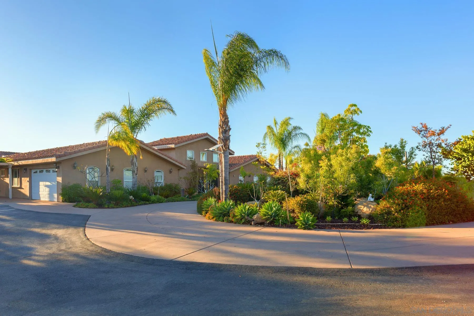 29314 Twin Oaks Valley Road Vista, CA 92084 - Photo 73 of 74 a front view of a house with a yard and garage