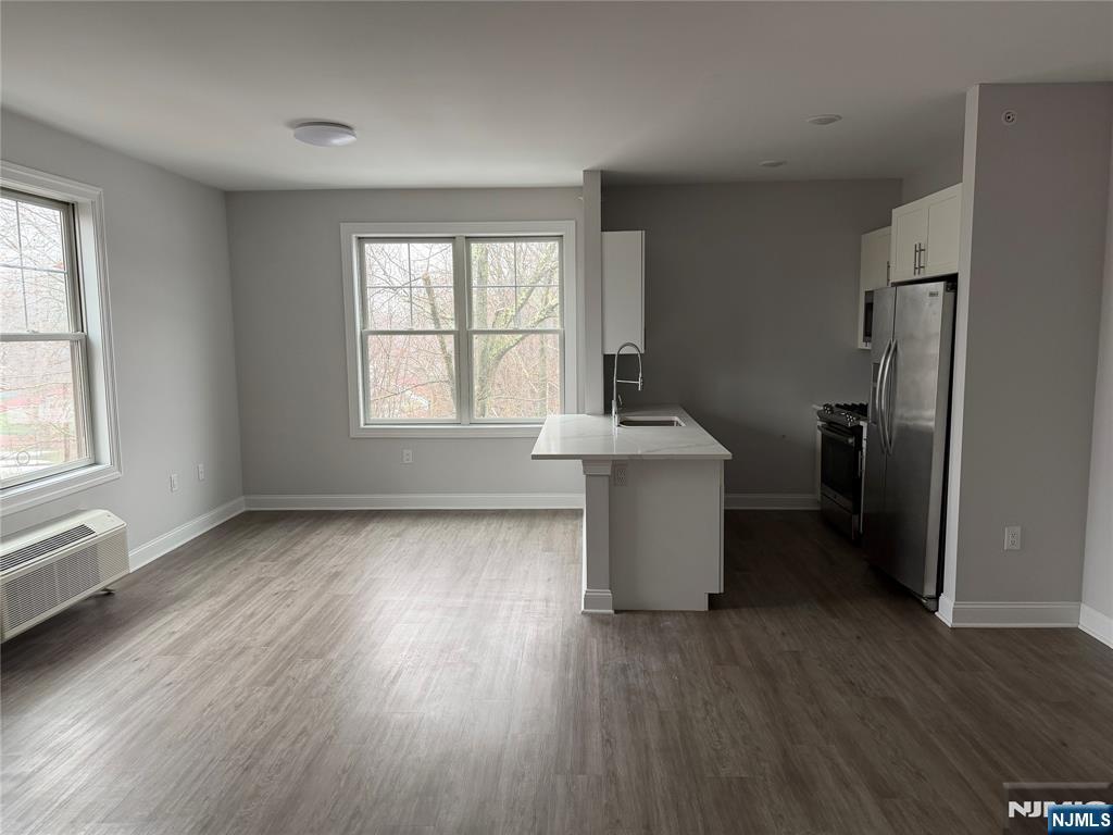 40 West Park Avenue, Unit 308 Park Ridge, NJ 07656 - Photo 4 of 9 a room with a window and wooden floor