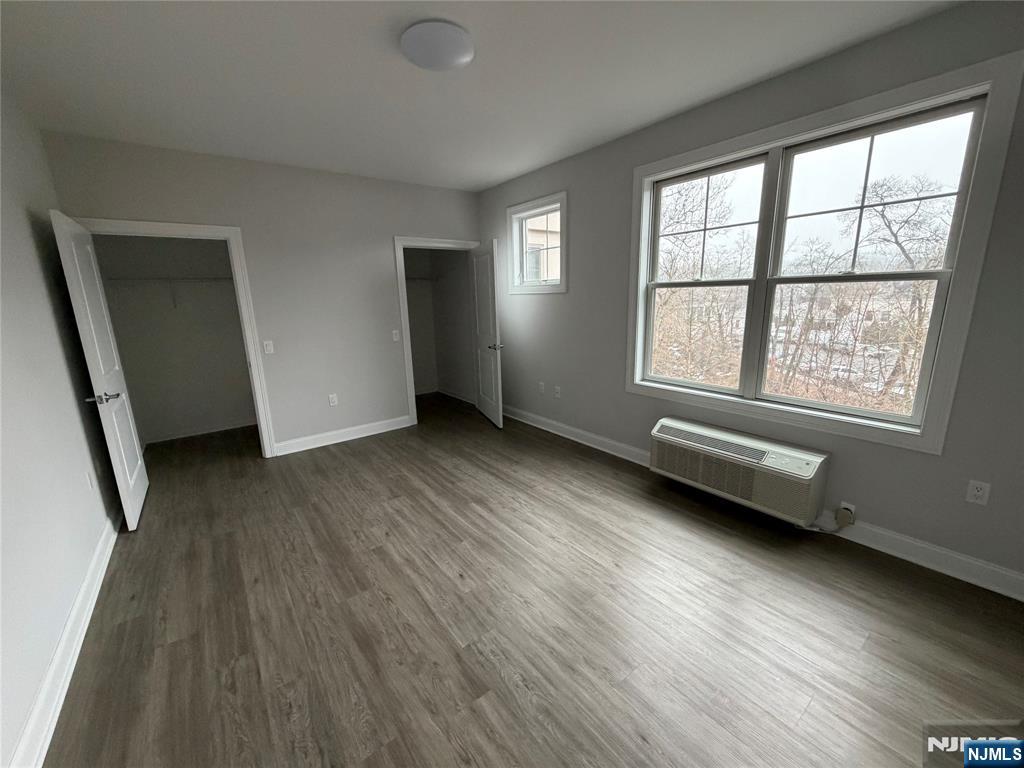 40 West Park Avenue, Unit 308 Park Ridge, NJ 07656 - Photo 5 of 9 an empty room with wooden floor and windows