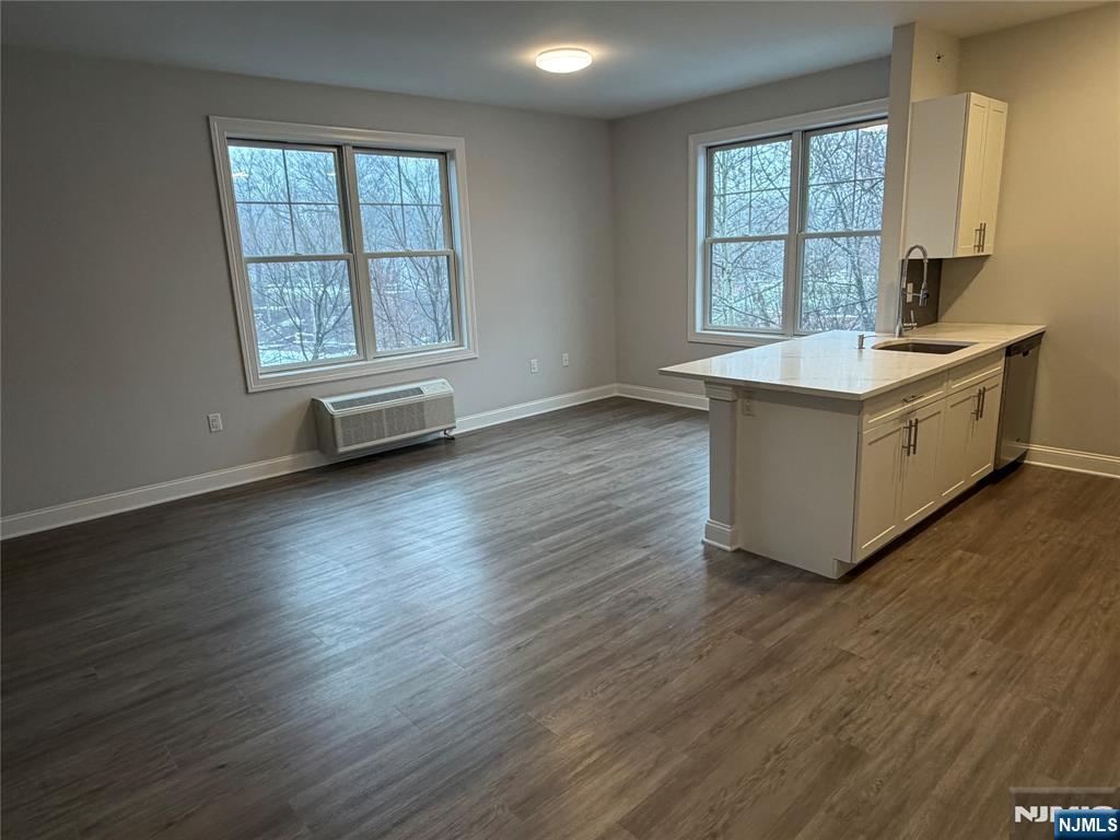 40 West Park Avenue, Unit 308 Park Ridge, NJ 07656 - Photo 6 of 9 an empty room with wooden floor and a window