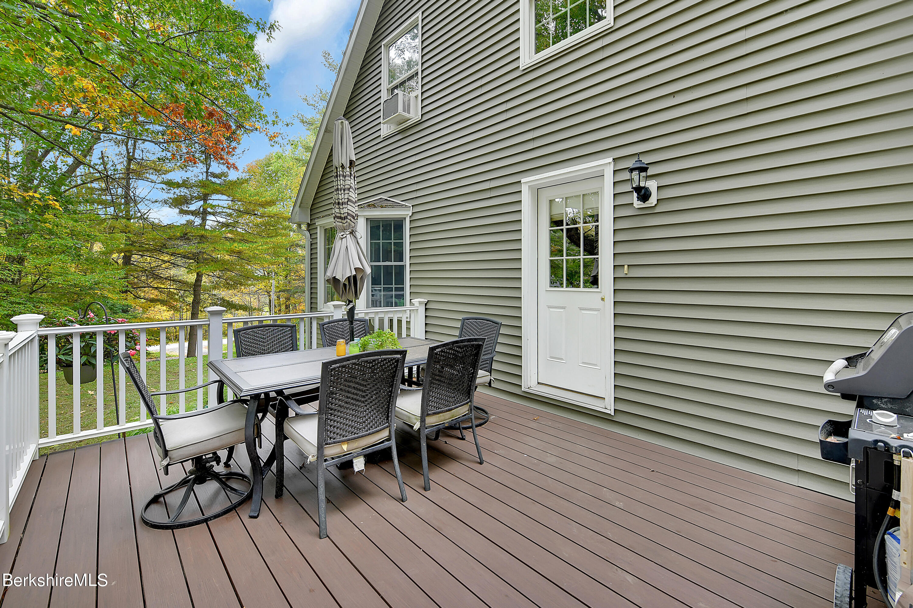 3 Ridge Street Tyringham, MA 01238 - Photo 31 of 38 a view of a deck with table and chairs and wooden floor