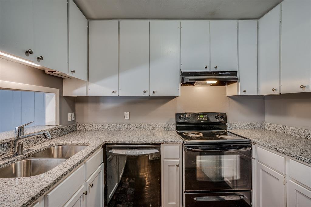 982 South Weatherred Drive, Unit B Richardson, TX 75080 - Photo 4 of 13 Kitchen featuring black appliances, under cabinet range hood, white cabinetry, and light stone counters