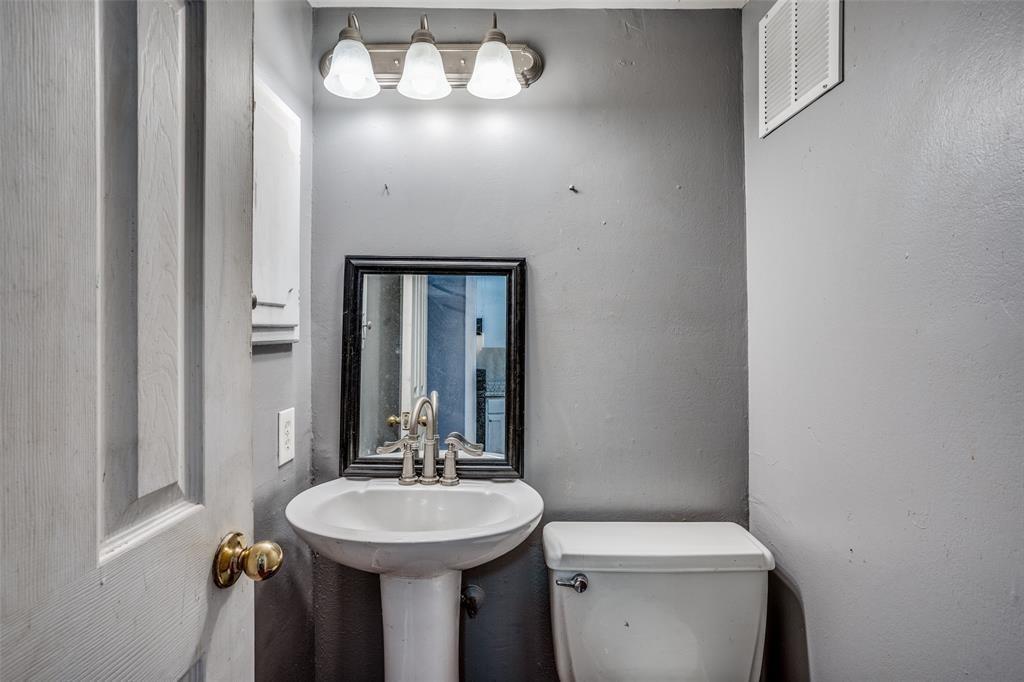 982 South Weatherred Drive, Unit B Richardson, TX 75080 - Photo 8 of 13 Half bathroom featuring toilet