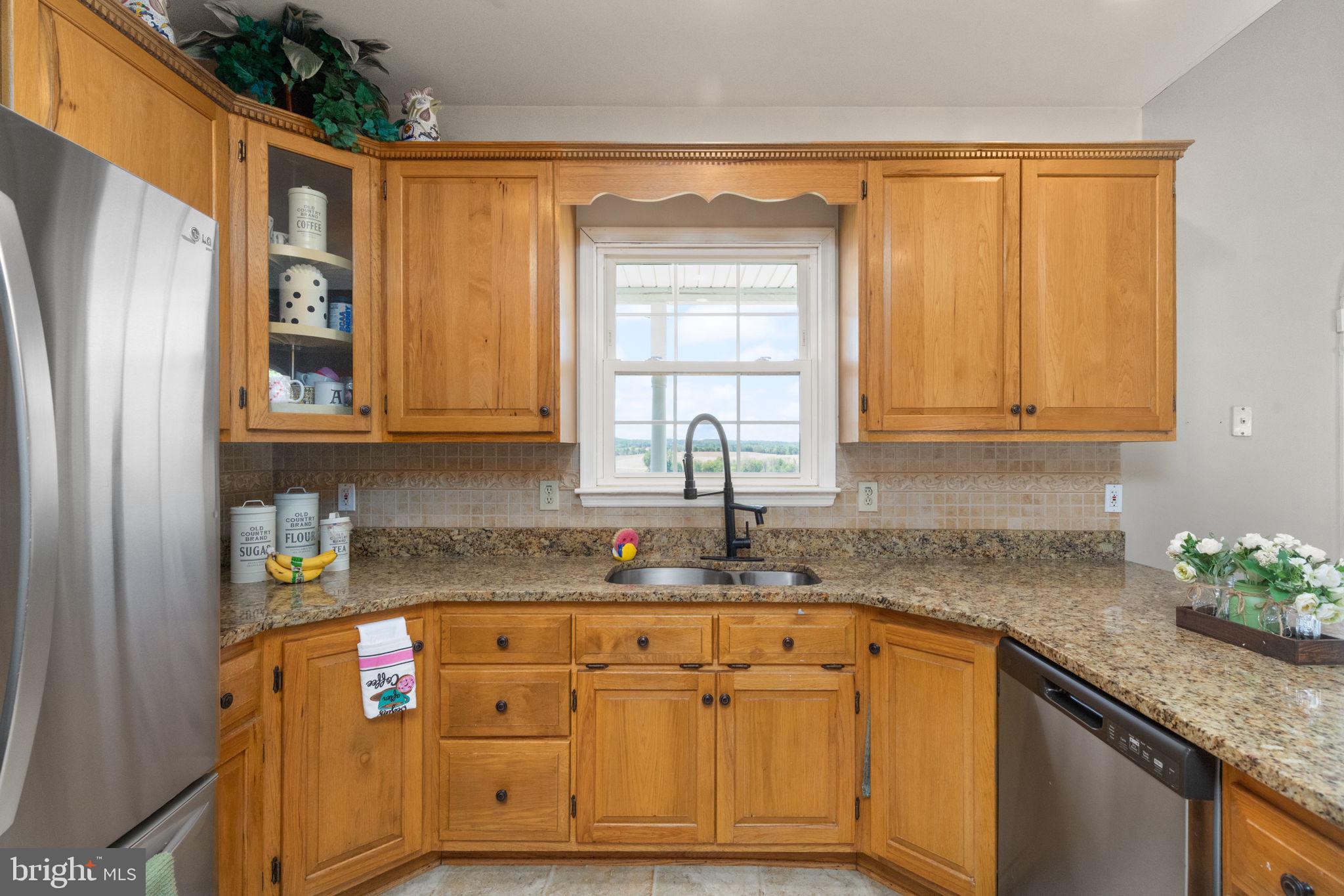 2140 Marston Road New Windsor, MD 21776 - Photo 12 of 48 a kitchen with granite countertop stainless steel appliances a sink window and cabinets