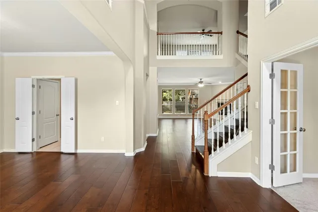 a view of entryway and hall with wooden floor