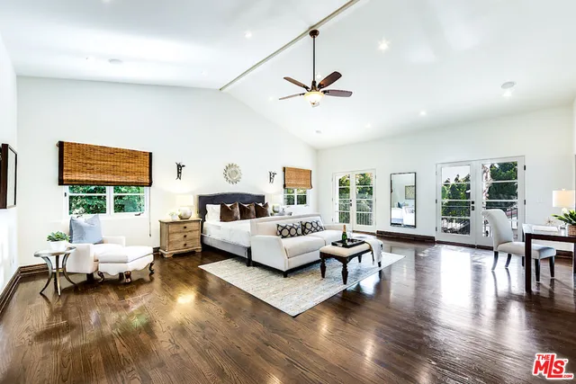 a spacious bathroom with a tub sink and mirror