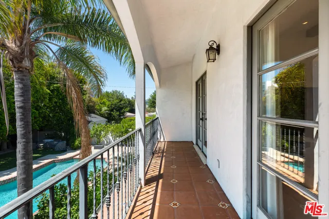 a kitchen with white cabinets and a window