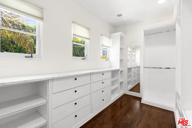 a bathroom with a double vanity sink toilet mirror and shower