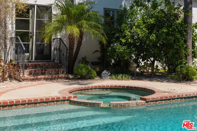 a view of a park with wooden fence and a bench