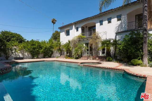 a view of a house with a yard patio and a garden