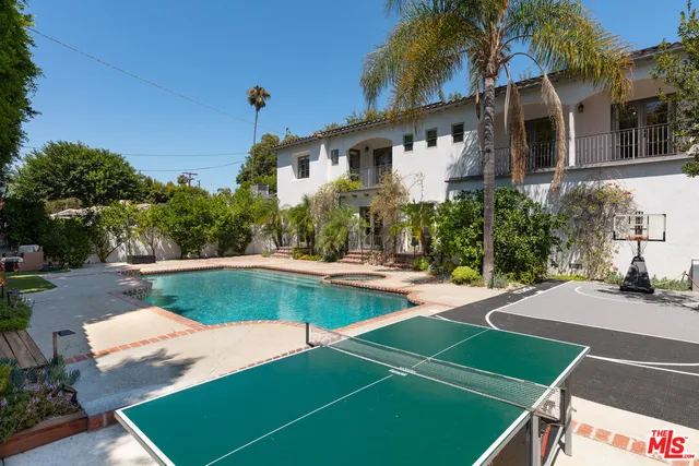 a front view of a house with a yard table and chairs