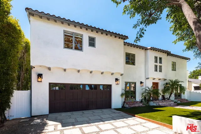 a living room with wooden floor and a rug
