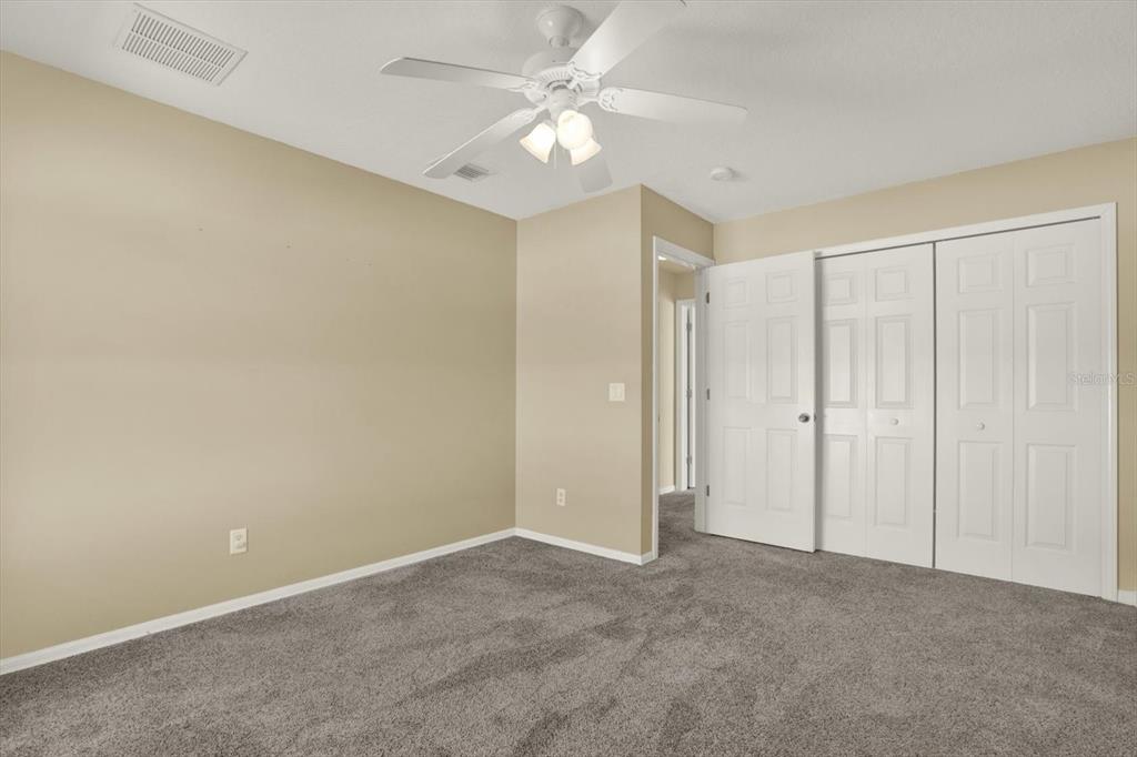 4400 Dior Road Spring Hill, FL 34609 - Photo 26 of 37 an empty room with closet and a ceiling fan