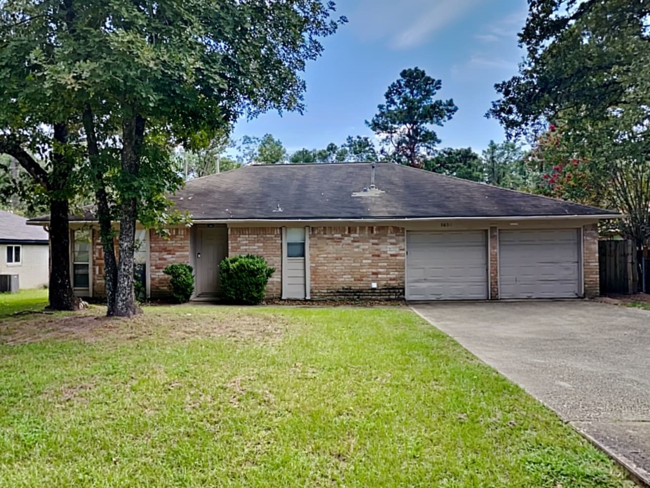 a front view of house with yard and trees