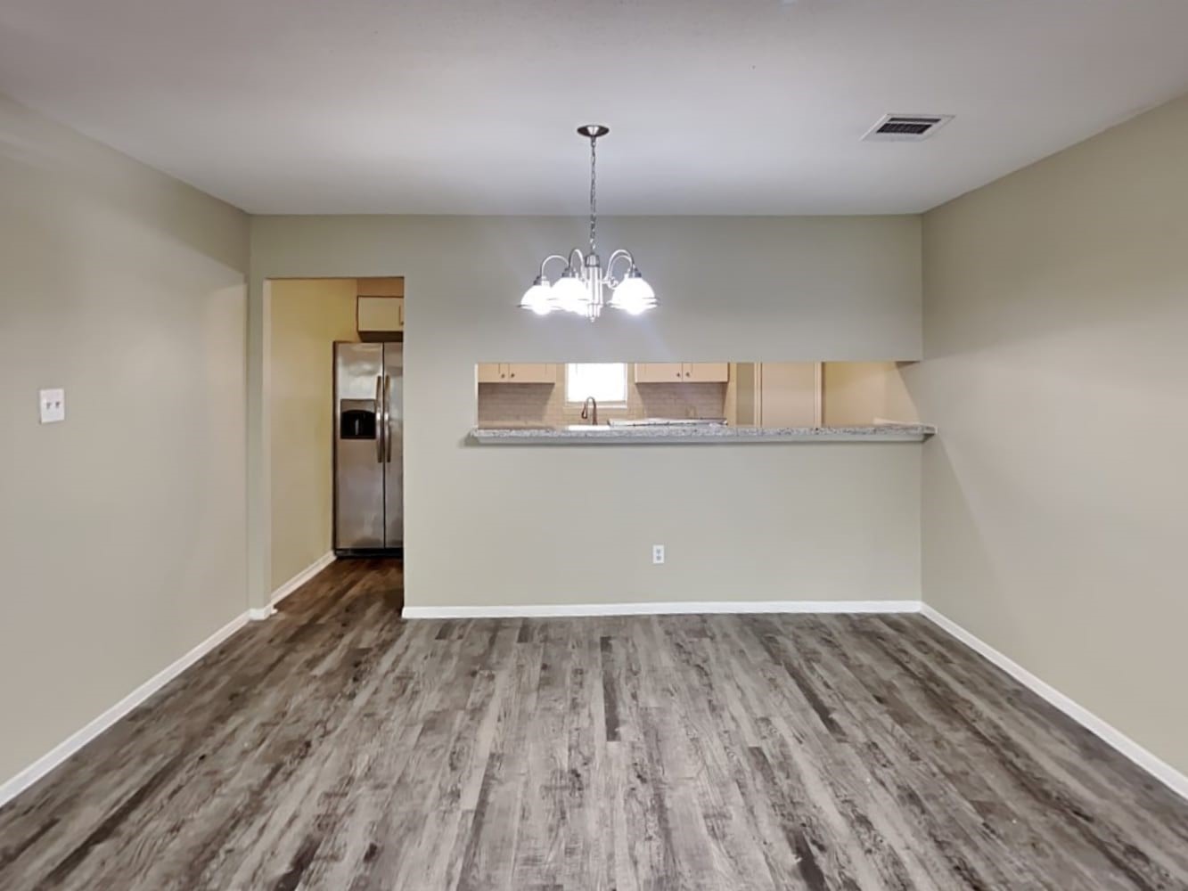3631 Dawnwood Drive Spring, TX 77380 - Photo 6 of 14 a view of a room with wooden floor and chandelier