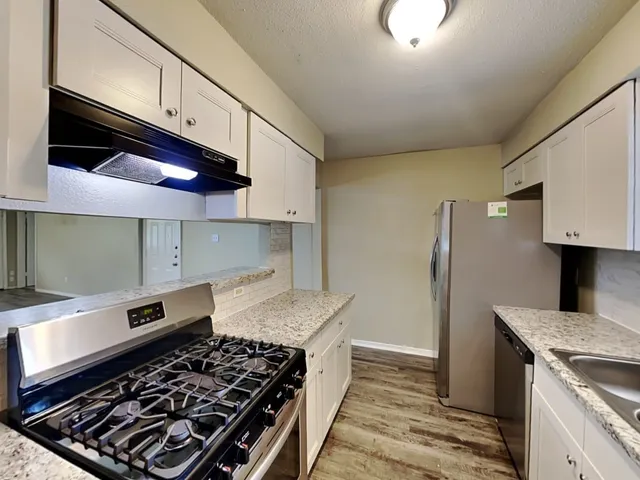 a kitchen with a stove and a refrigerator