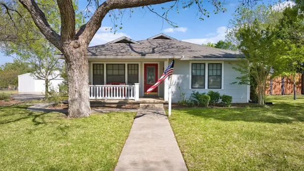 a front view of a house with a yard and table and chairs