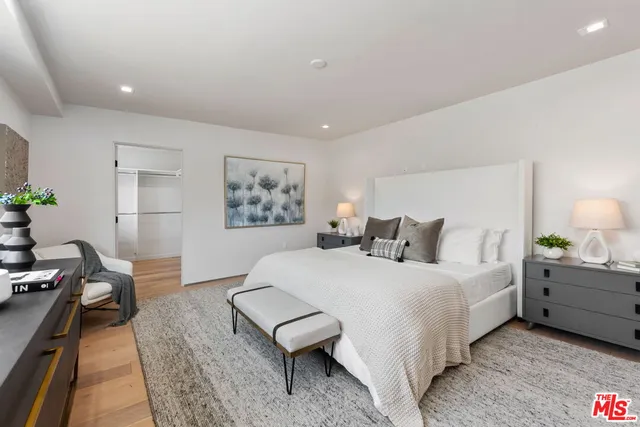 a bedroom with a bed and a lamp on table