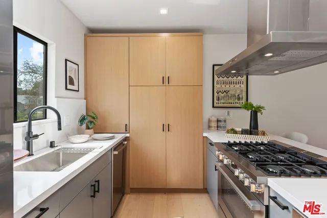 a kitchen with a sink stove and refrigerator