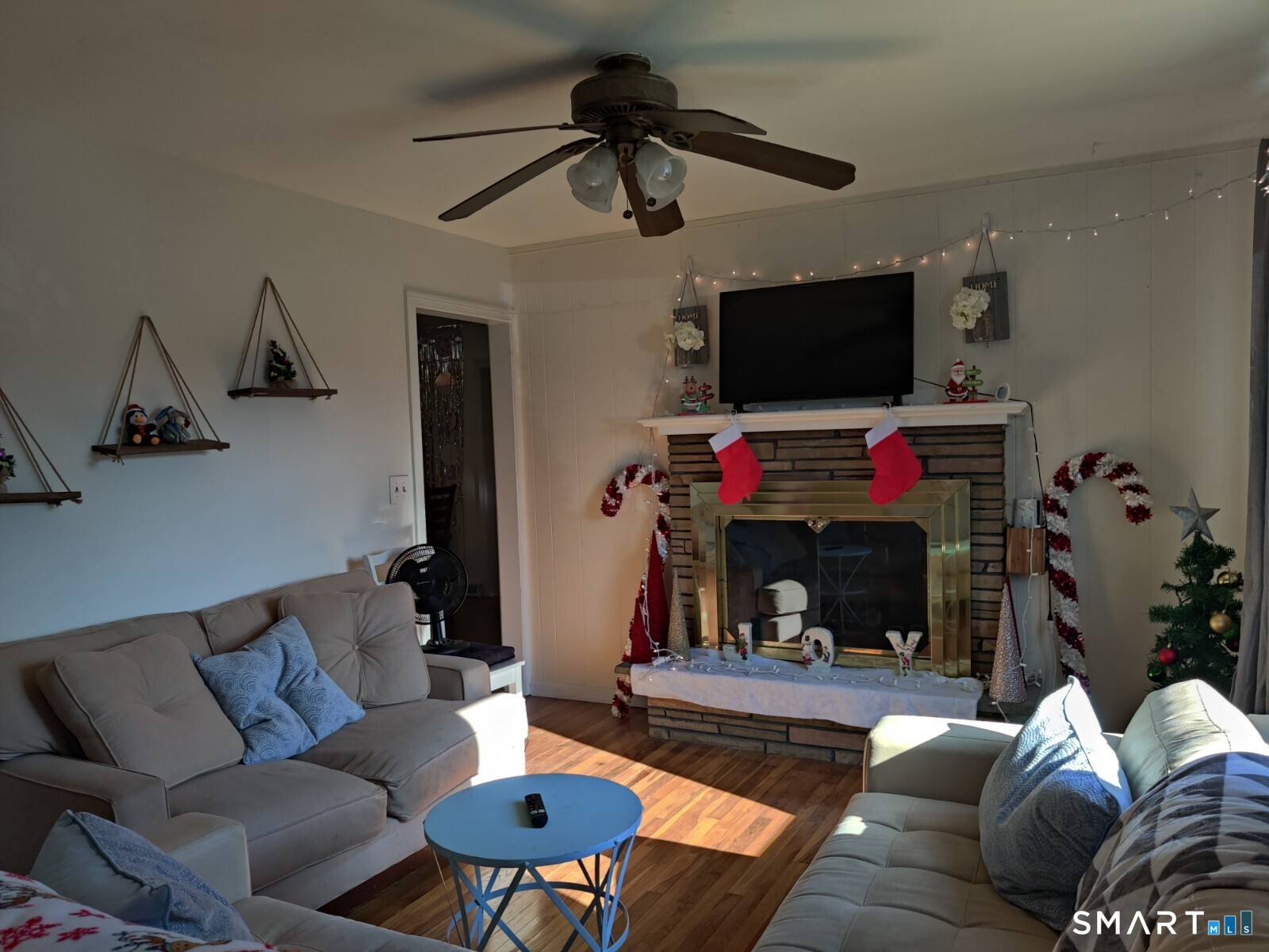 100 Loftus Circle Bridgeport, CT 06606 - Photo 4 of 16 a living room with furniture a flat screen tv and a fireplace